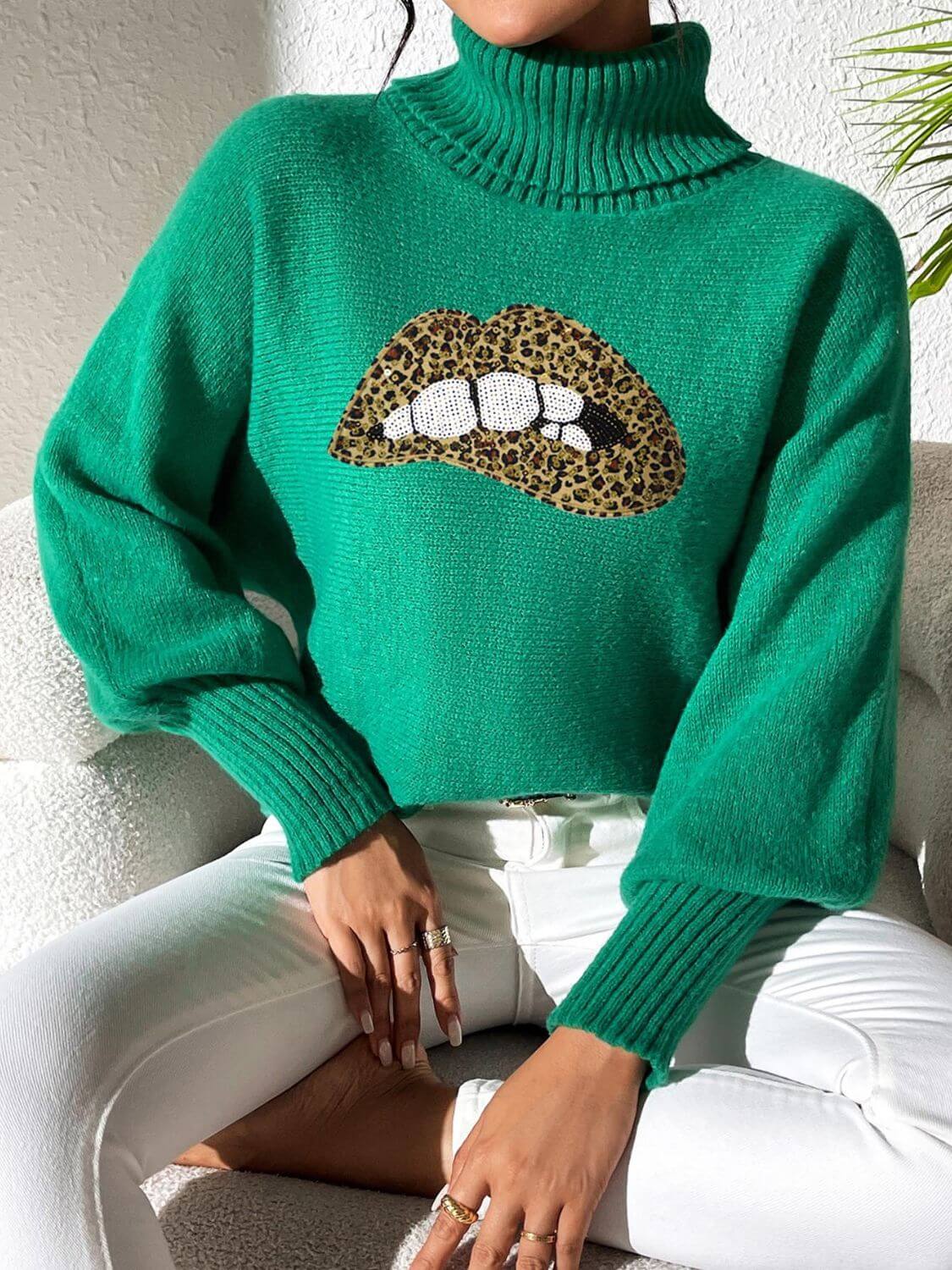 Green Bella Road Lip Turtleneck Sweater with bold lip design, featuring moderate stretch and playful style for unique fashion statements.