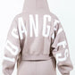 Back view of American Bazi 'Los Angeles' cropped hoodie in beige, featuring bold white lettering and a drawstring hood.