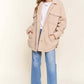 Cozy teddy sherpa button-down shacket with curved hem, styled with jeans and boots for a chic casual look.