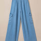 Light wash wide leg cargo jeans with drawstring waist and spacious pockets for a trendy, comfortable look.