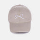 Bow Embroidered Washed Cotton Cap in beige with delicate bow design on front, breathable and stylish accessory for all-day wear.