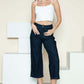 Woman wearing Judy Blue side seam braid detail crop wide leg jeans with white top and sandals.