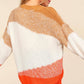 Woman wearing a Haptics Color Block Long Sleeve Sweater with bold orange, cream, and tan shades, styled for a casual outing.