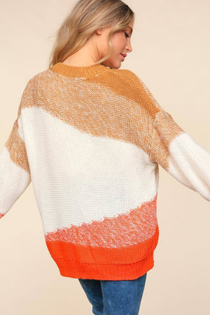 Woman wearing a Haptics Color Block Long Sleeve Sweater with bold orange, cream, and tan shades, styled for a casual outing.