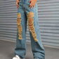 Woman wearing Bella Road Distressed Wide Leg Jeans with Pockets featuring ripped details and paired with white chunky sneakers.