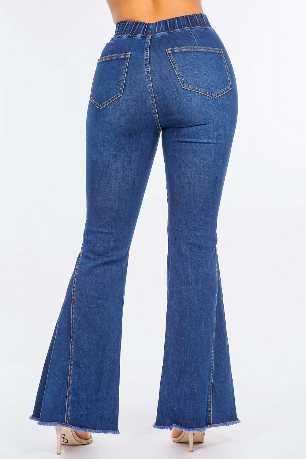 High waist curvy flare jeans with elastic banded waist, slim fit, and retro flare bottom in blue denim material viewed from the back.