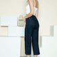 Woman wearing Judy Blue crop wide leg jeans with side seam braid detail, styled with a white top and heels for a chic look.