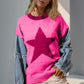 Woman wearing Double Take Star Pattern Raw Edge Long Sleeve Sweater in pink with denim sleeves.