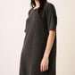 Stylish woman wearing a Mittoshop Urban Rib Knit Short Sleeve Tee Dress, pairing casual comfort with modern flair.