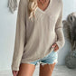 Woman wearing Double Take Pocketed Textured V-Neck Long Sleeve T-Shirt with denim shorts, showcasing casual style and comfort.