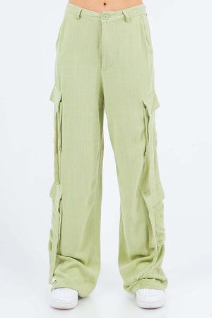 Light green linen wide leg cargo pants with utility pockets and button closure.