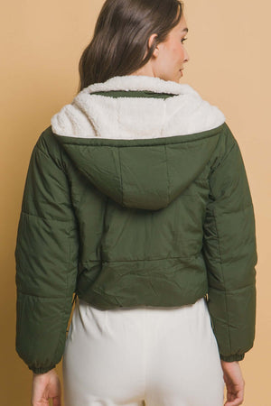 Woman wearing green cropped hooded Sherpa reversible jacket, showcasing the cozy and stylish back design for a chic winter look.