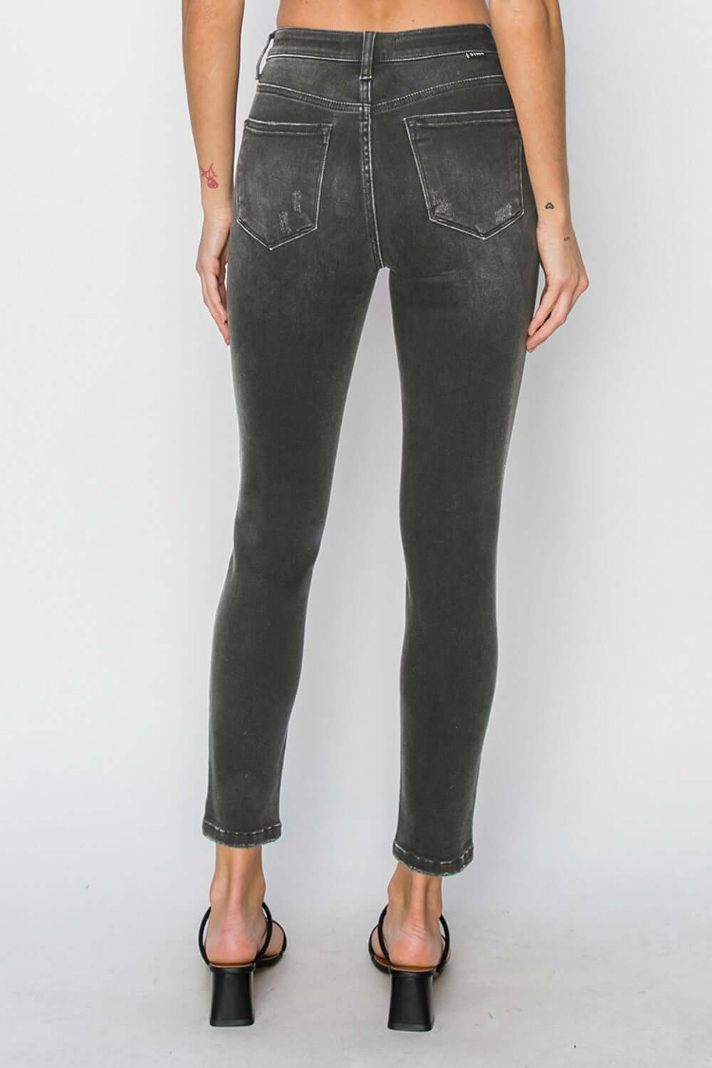 Back view of RISEN Full Size High Rise Ankle Skinny Jeans highlighting the slim fit and high-waisted design.