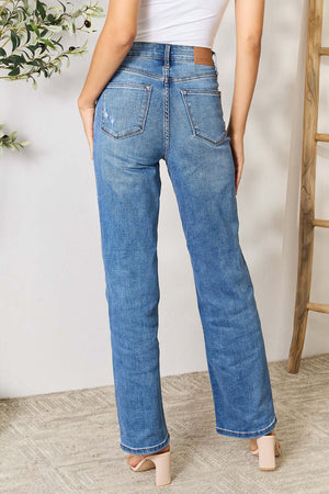 Back view of model wearing high waist distressed full-size Judy Blue Jeans with a white top and beige heels.