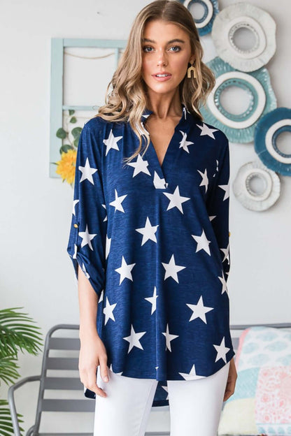 Woman wearing Heimish full-size roll-tab sleeve star print top in navy blue with white stars