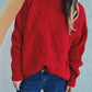 Woman wearing Bella Road Diamond Round Neck Long Sleeve Sweater in red with unique diamond pattern and blue jeans