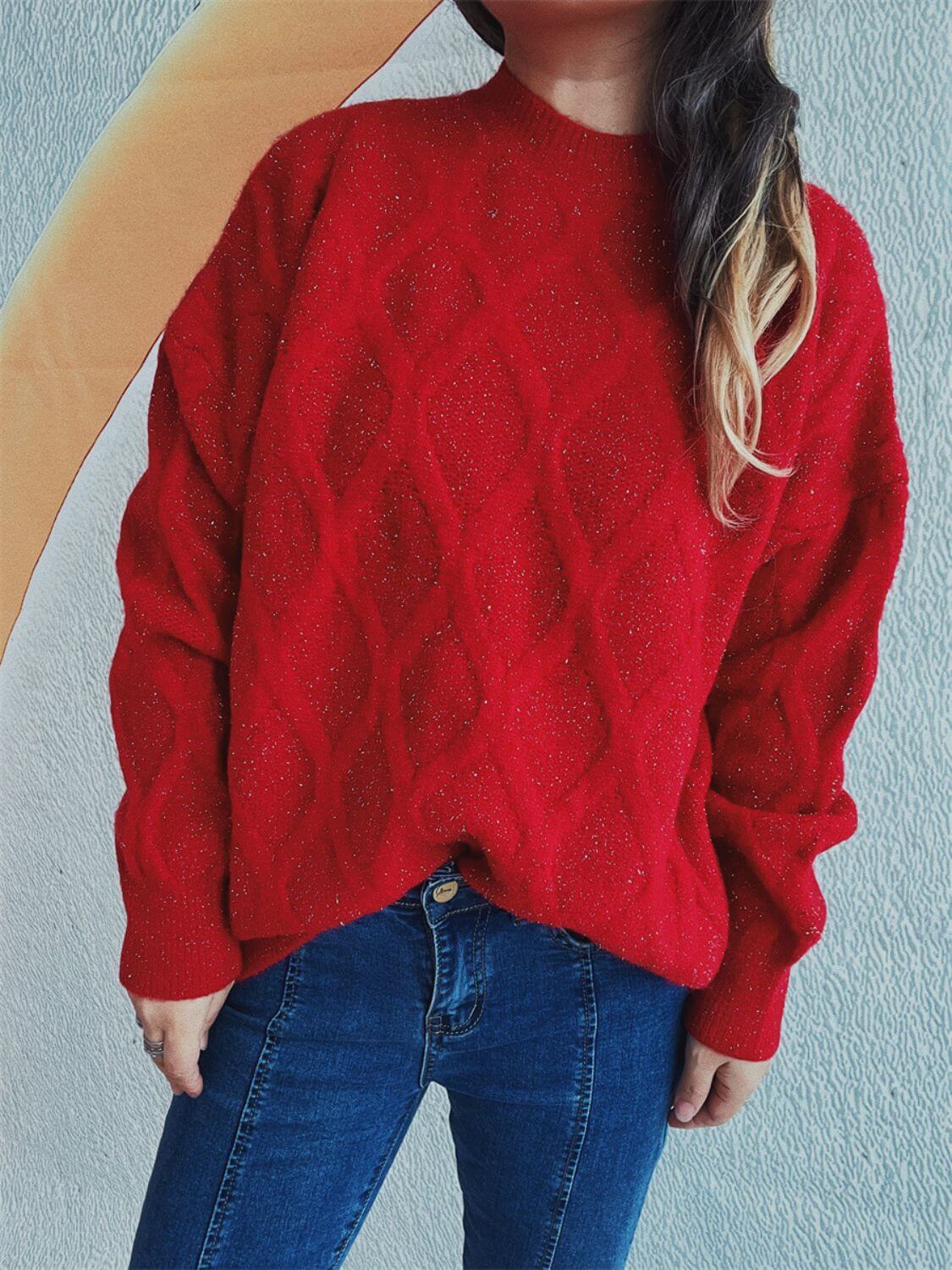 Woman wearing Bella Road Diamond Round Neck Long Sleeve Sweater in red with unique diamond pattern and blue jeans