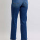 Back view of Judy Blue Full Size Straight Jeans showcasing side seam detail and pockets, styled with heeled sandals.