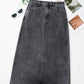 Bella Road raw hem midi denim skirt with pockets styled with sunglasses and greenery for an edgy, adventure-ready look.