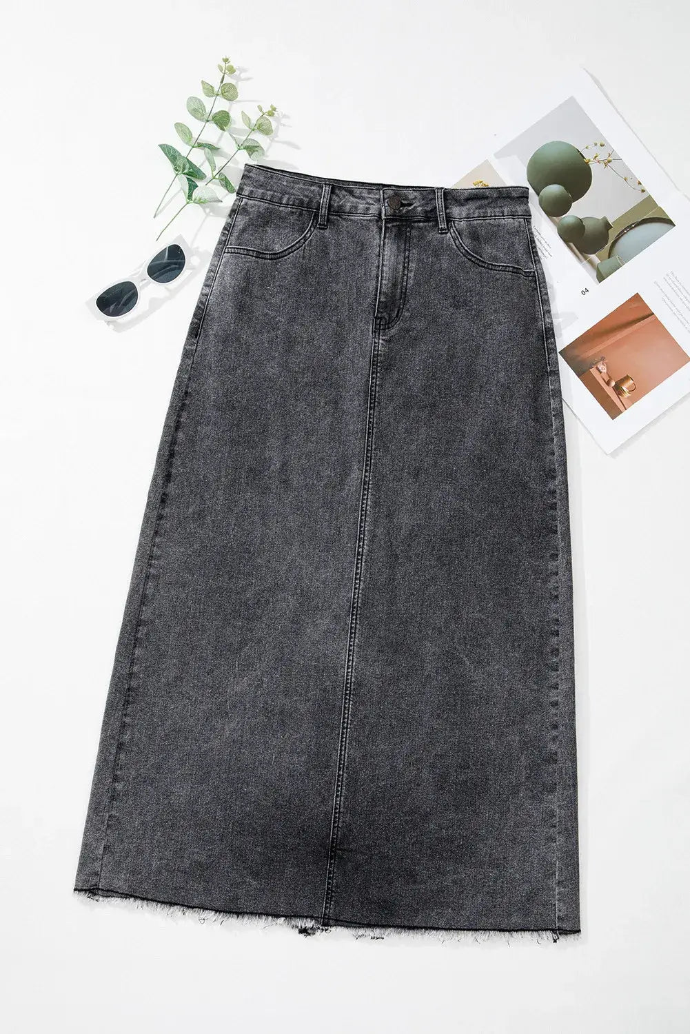 Bella Road raw hem midi denim skirt with pockets styled with sunglasses and greenery for an edgy, adventure-ready look.