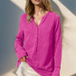 Woman wearing a double take full-size notched thumbhole long sleeve t-shirt in pink, paired with a white skirt.