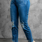 Stylish distressed cropped jeans with slightly stretchy material and raw hem, shown in a studio setting.