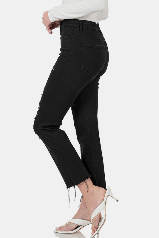 Side view of Zenana distressed raw hem cropped jeans with sleek black fabric and stylish heels. Perfect for any casual chic outfit!