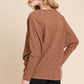 Woman wearing brown BOMBOM knit top with long dolman sleeves and black shorts, showcasing a relaxed and stylish fit.