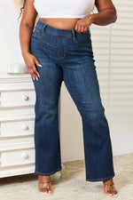 Woman wearing Judy Blue elastic waistband slim bootcut jeans in full size, featuring a comfortable and stretchy fit.