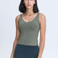 Stylish model wearing a Millennia V Neck Active Tank in olive green, perfect for workouts and athleisure.