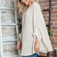 Woman wearing cozy Bella Road Round Neck Batwing Sleeve Sweater, showcasing stylish batwing sleeves and soft fabric.