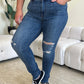 Woman wearing high waist distressed skinny jeans from Judy Blue Jeans, featuring stretchy denim fabric and a flattering fit.