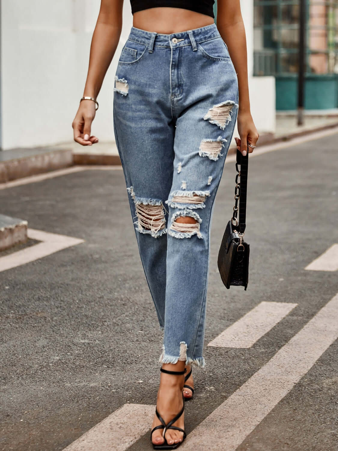 Bella Road Distressed Raw Hem Jeans with Pockets worn by a model, showcasing the stylish design and slightly stretchy fit