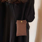 Bella Road Suede Snap Down Crossbody Bag worn on a woman's back with a black outfit.