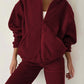 Cozy Bella Road burgundy zip-up hoodie and joggers set, perfect for fall outings or lounging, featuring pockets and a relaxed fit.