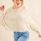 Woman wearing cozy Dolman Sleeves Sweater with relaxed fit and trendy design, paired with jeans, perfect for cooler months.