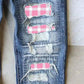 Distressed printed straight jeans with pink and pumpkin plaid patches, showcasing a unique edgy design for a stylish denim collection.