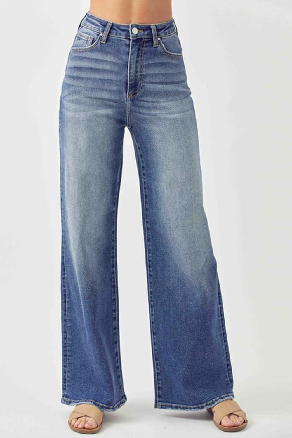 Woman wearing Risen Jeans high rise wide leg jeans with flattering high waist design for a chic and stylish look.