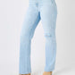 Woman wearing high waist distressed straight Judy Blue jeans full size with knee rip, paired with tan heeled boots.