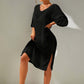 Woman wearing a black slit V-neck flounce sleeve cover-up, backless and sheer with no stretch, made of 100% polyester.