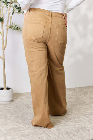 Woman wearing Risen Jeans fringe hem wide leg jeans with a high-waisted, flattering fit and trendy style for versatile occasions.