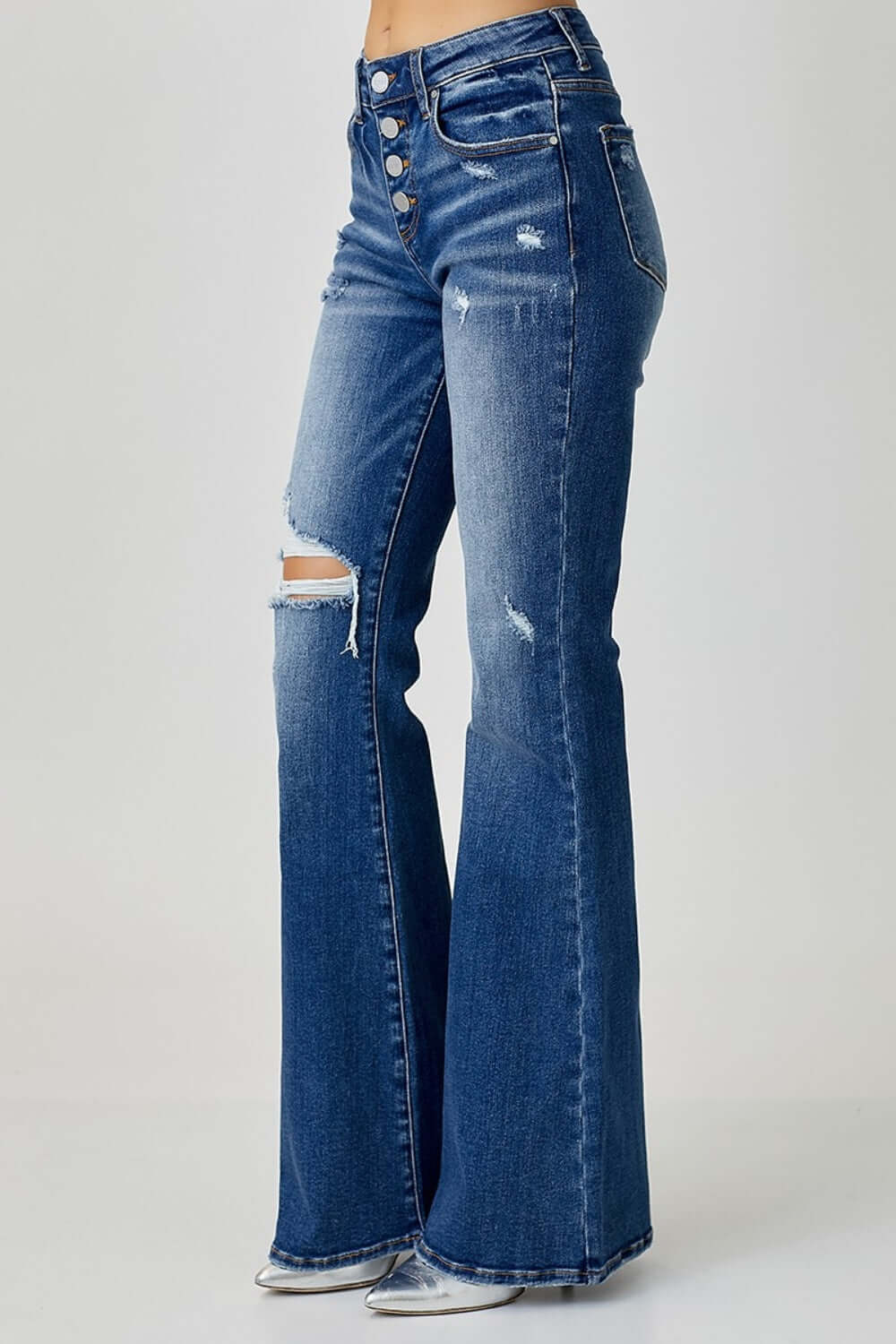 Distressed button-fly flare jeans by Risen Jeans, featuring a trendy flared design, pockets, and slight stretch in blue denim.