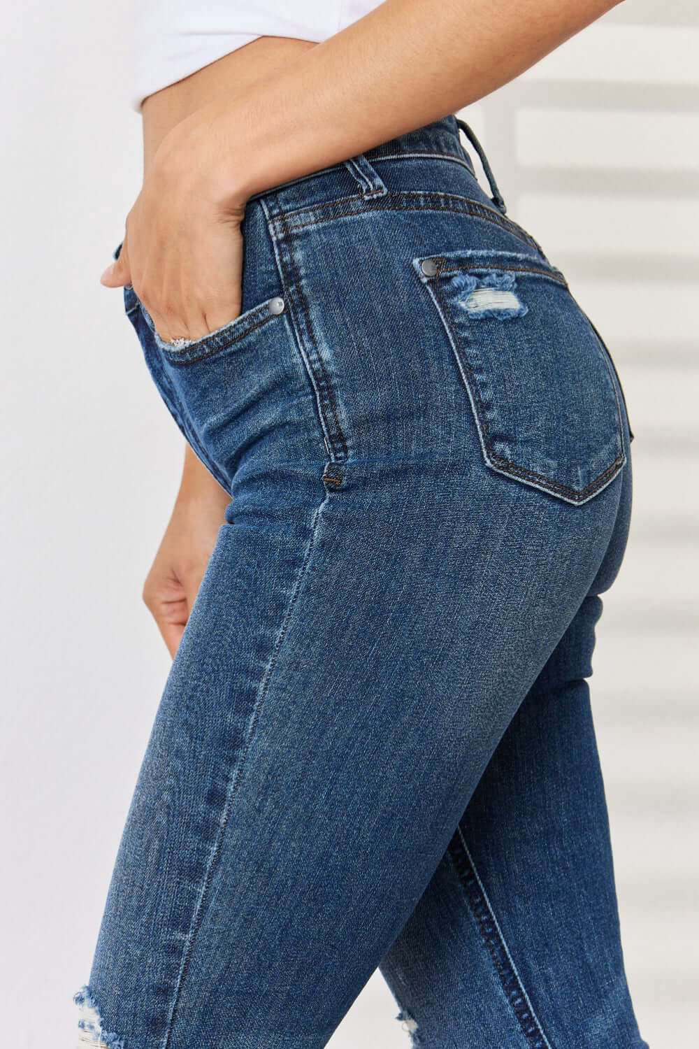 Mid Waist Distressed Slim Judy Blue Jeans featuring a flattering mid-rise and slim fit with trendy distressed detailing.