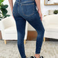 Woman wearing Classic Handsand Skinny Judy Blue Jeans showcasing a flattering fit with a hand-sanded finish for a vintage look