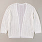 Openwork open front dropped shoulder white cardigan made of acrylic and cotton, displayed on a gray background.