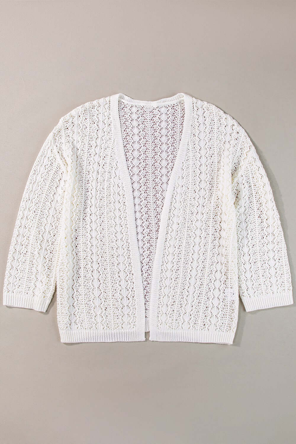 Openwork open front dropped shoulder white cardigan made of acrylic and cotton, displayed on a gray background.