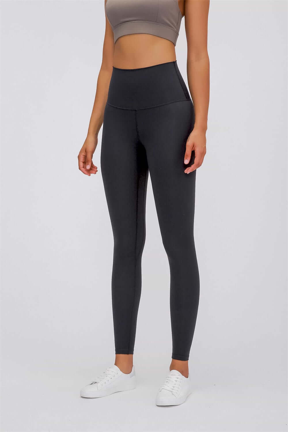 Model in Millennia Ultra Soft High Waist Leggings, showcasing a sleek look with a comfy cropped top and sneakers.