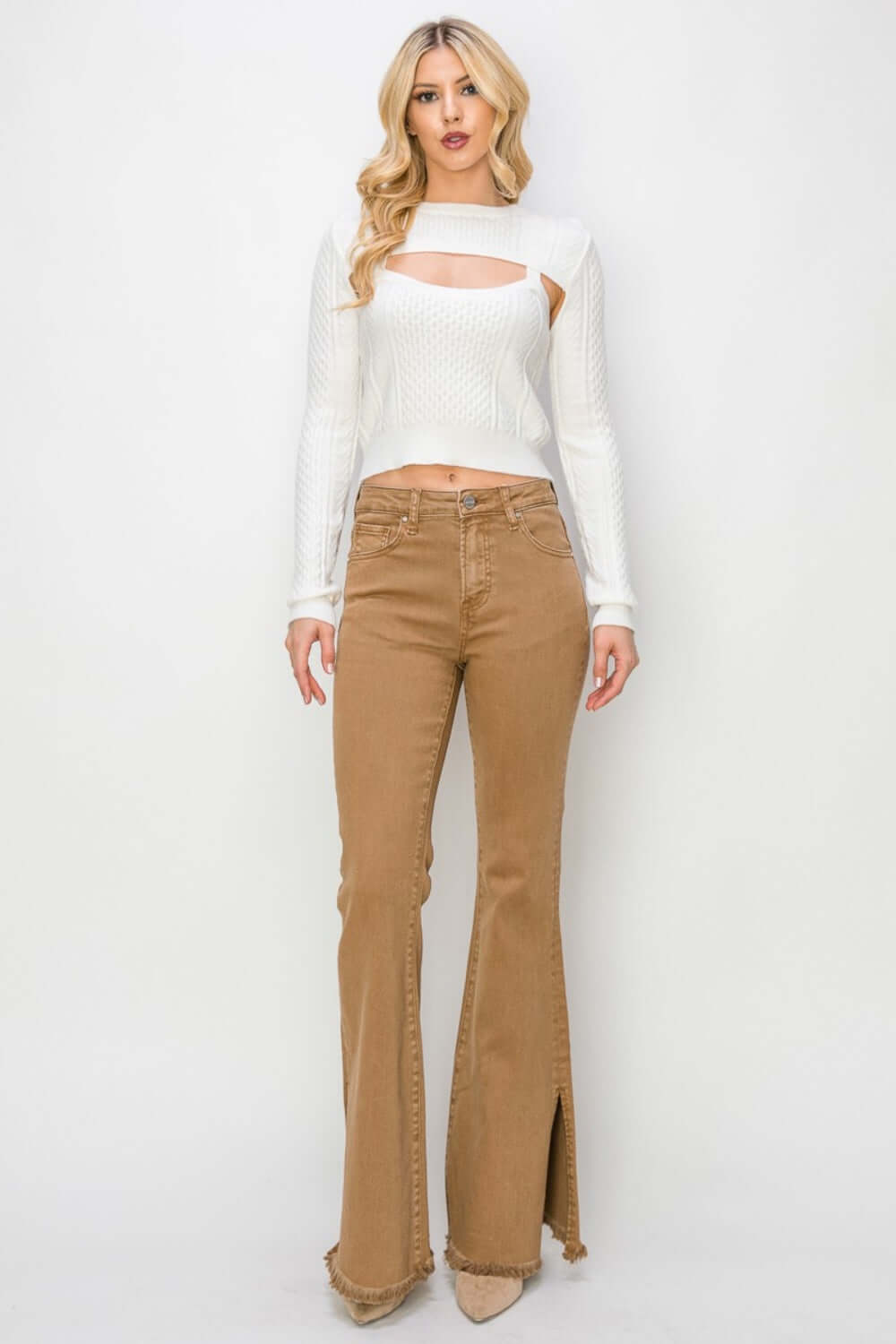 Fashionable woman in Bailey High Waist Side Slit Flare Jeans by Risen Jeans, showcasing the edgy side slit and trendy high-rise fit.