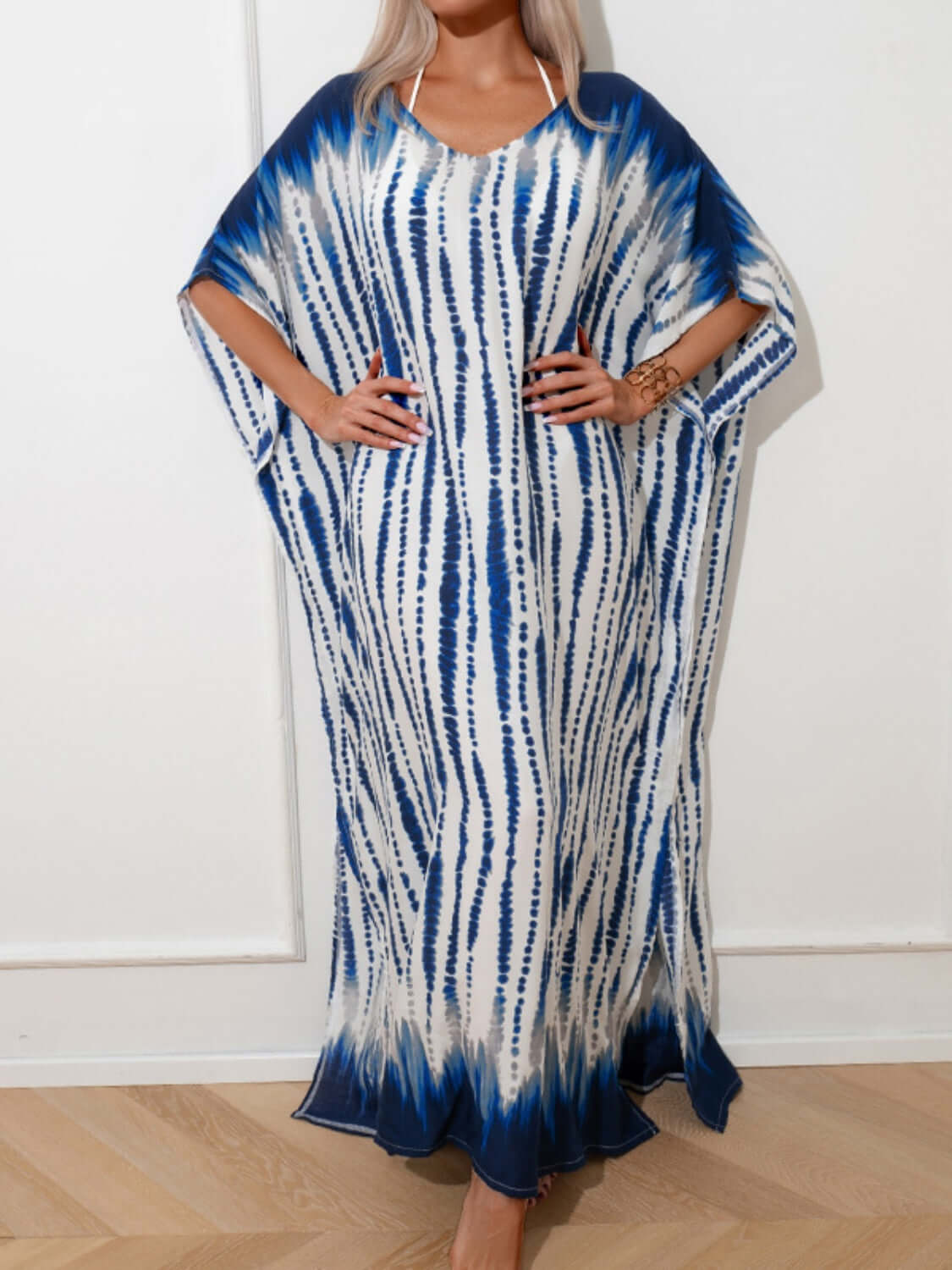 Woman wearing a blue and white slit tie-dye half sleeve cover up with a slightly stretchy and opaque fabric made of 100% cotton.