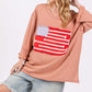 Woman wearing Full Size American Flag Patch Drop Shoulder T-Shirt with denim shorts and cap